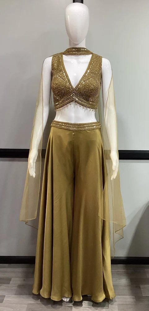 Gold-and-champagne embellished co-ord set on a plain shop mannequin — the boutique's original phone photo