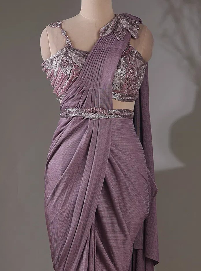 Close crop of a mauve pre-draped saree on a mannequin — embellished blouse, petal shoulder appliqué and belt: the photo the boutique sent